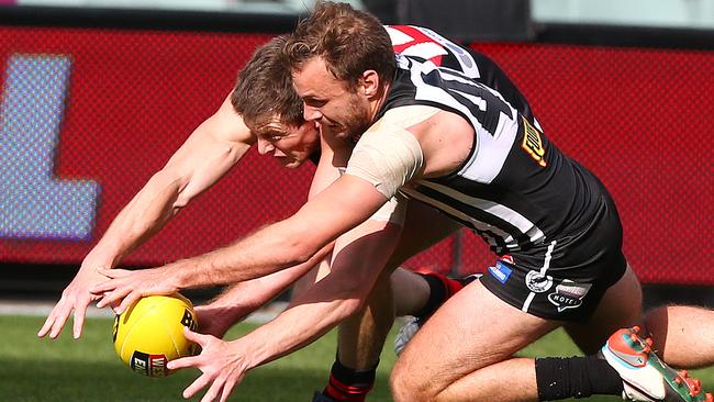 Jon Beech and Tom Logan battle for the ball at Adelaide Oval. Photo: Sarah Reed.