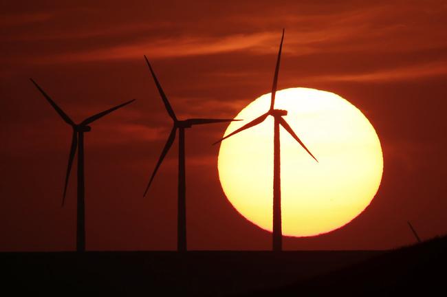 FILE - In this Aug. 23, 2013 file photo, wind turbines are silhouetted by the setting sun as they produce electricity . (AP Photo/Charlie Riedel, File). Picture: Charlie Riedel