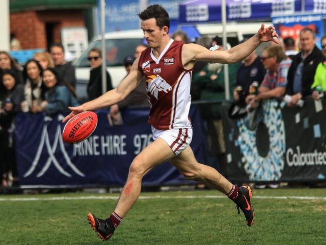 Michael McDougall gets a kick away. Picture: Davis Harrigan