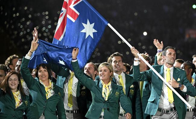 Australian flag bearer Mark Knowles (right) leads the team into the stadium during the Opening Ceremony of the XXI Commonwealth Games at Carrara Stadium, on the Gold Coast, Wednesday, April 4, 2018. (AAP Image/Dean Lewins) NO ARCHIVING, EDITORIAL USE ONLY. Picture: DEAN LEWINS