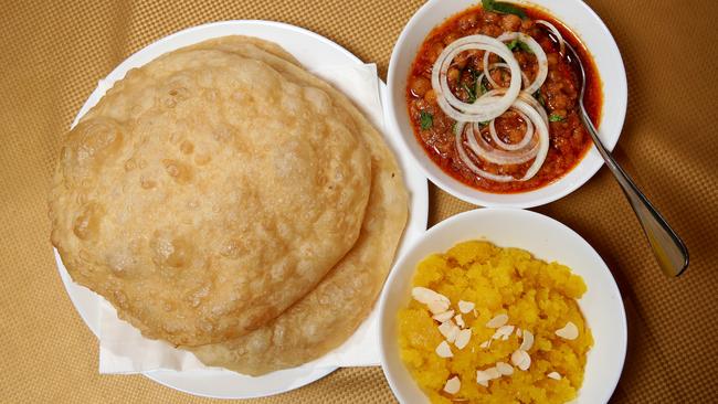 From L-R; puri bread, lahori chani and halwa is a typical Pakistani breakfast at Lahori Dhaba a Pakistani restaurant in Punchbowl. Picture: Jonathan Ng