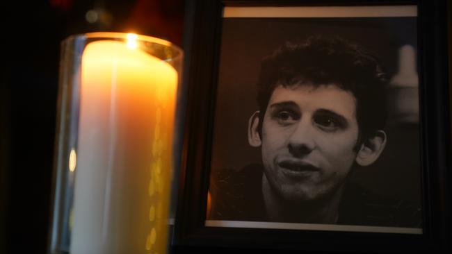 A candle burns next to a photograph of MacGowan at the Mansion House in Dublin.