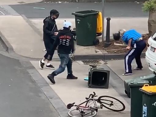 One of the attackers throws his bike helmet at the elderly man. Picture: Supplied