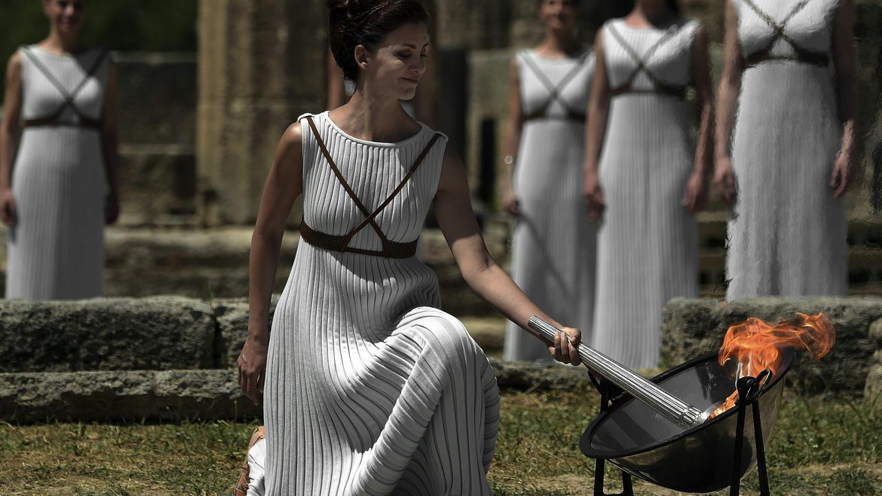 An actor recreates the ancient lighting of the Olympic flame at the Temple of Hera in Olympia before the torch and flame made their way to the Rio Olympic Games in 2016. Picture: AFP