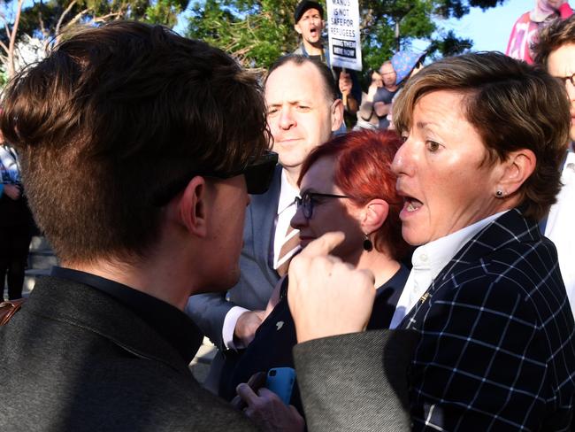 Christine Forster, right, is confronted by protesters as she attends a Liberal Party fundraiser hosted by her brother Tony Abbott in Redfern, Sydney on Friday. Picture: AFP/William West
