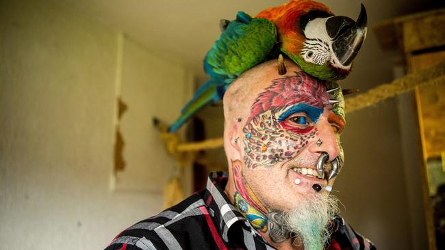 Ted Richards, from Hartcliffe in Bristol recently hit the headlines when he had his ears cut off to look like his parrot. He also had his eyeballs dyed blue. Picture: SWNS.