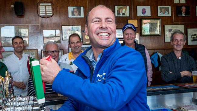 Treasurer Josh Frydenberg celebrates with some beers at Auburn Bowls Club. Picture: Jake Nowakowski