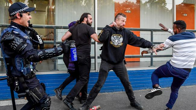 Protesters attack a man from a right wing affiliated group. Picture: Jake Nowakowski