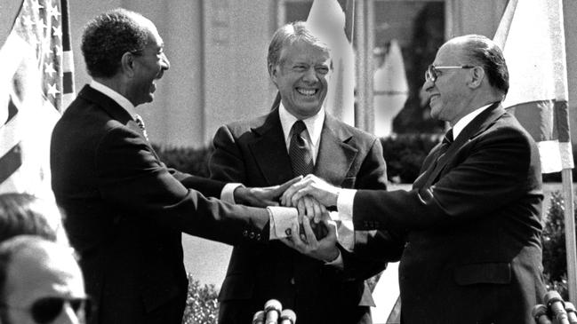 Egyptian President Anwar Sadat, US President Jimmy Carter and Israeli Prime Minister Menachem Begin clasp hands in the White House, March, 1979.