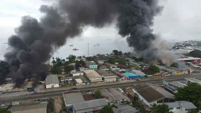 Buildings burn along the Prince Philip highway in Honiara on Thursday. Picture: Jone Tuiipelehaki