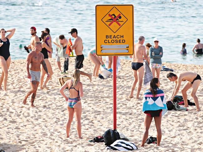 Large crowds leaving Coogee beach after 9am closure on 26th of April 2020. Photographer: Adam Yip