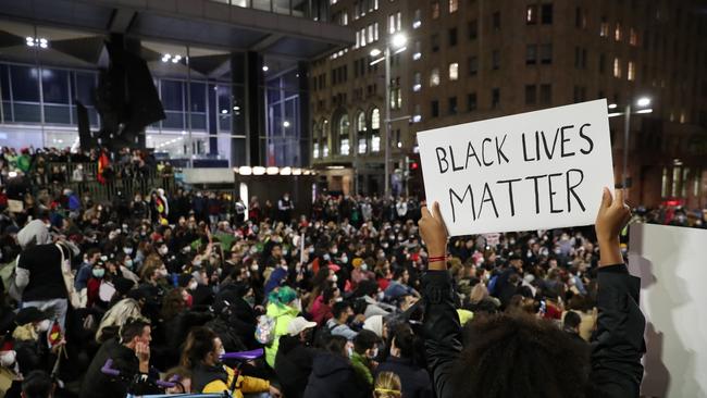 Sade Fajemisin, 21, holding up a sign during a protest in Martin Place in Sydney to bring awareness to police brutality. Picture: Jonathan Ng