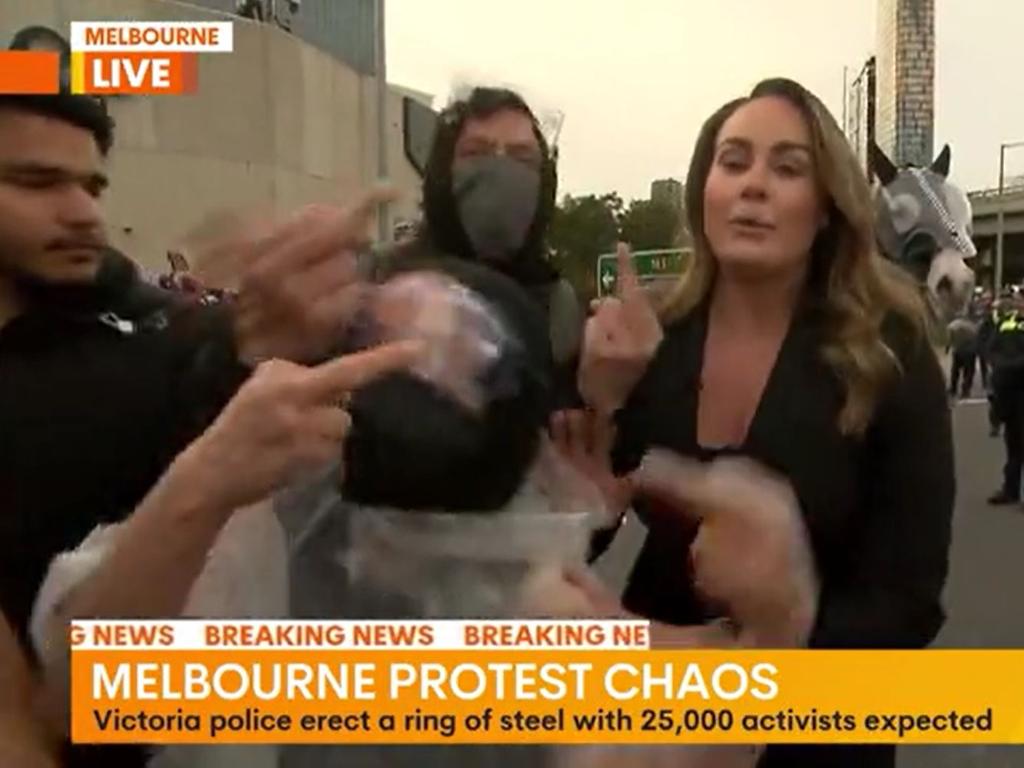 Channel 7 reporter Teegan Dolling was swarmed at the Melbourne rally. Picture: Channel 7