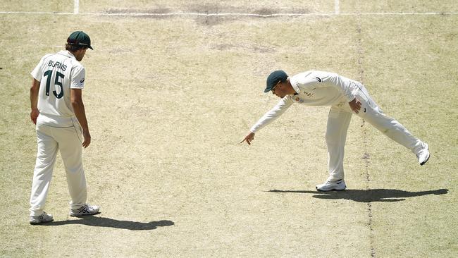 David Warner and Joe Burns inspect cracks in the pitch on day three. Picture: Getty Images