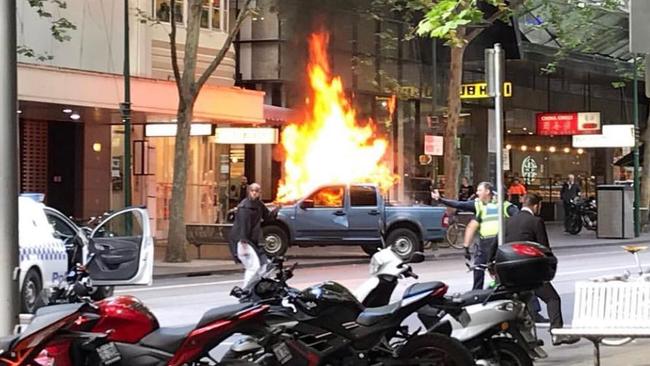 Twitter image of a car on fire on Bourke St. Picture: Chris Macheras