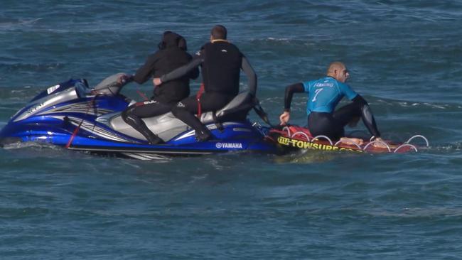 Mick Flanning sits on board a rescue boat after being pursued by a shark