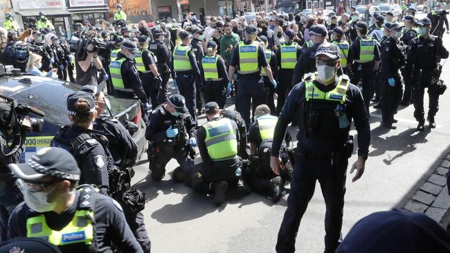 Police make arrests at Victoria Market during anti-lockdown protests in Melbourne. Picture: David Crosling