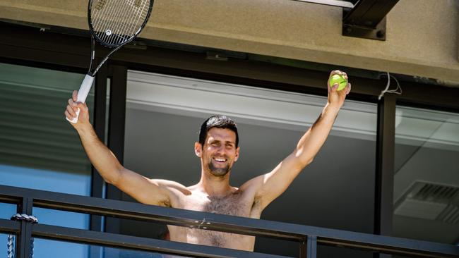 Novak Djokovic waves to fans from a balcony of the Adelaide hotel where he is completing his quarantine. Picture: AFP