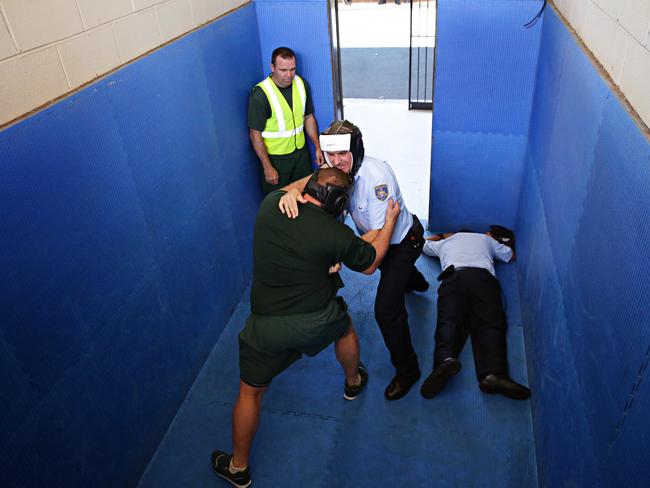 Officers run through a ‘man down’ scenario at Brush Farm Corrective Services Academy. Picture: Adam Yip