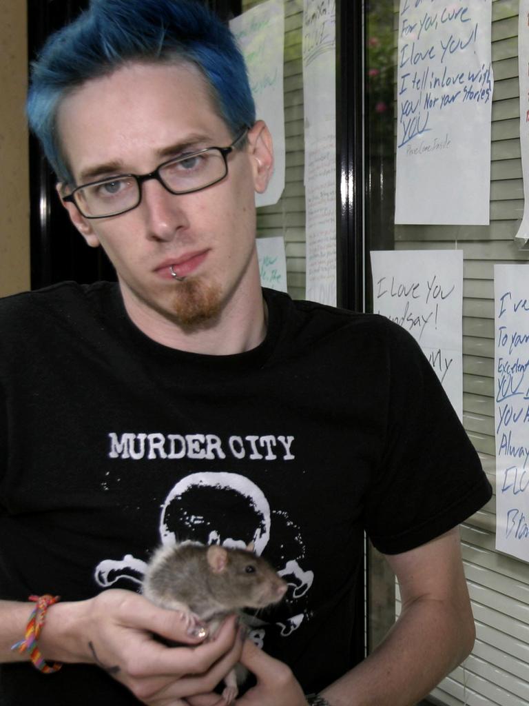 Ms Van Blanken’s finance Brandon, with one of her pet rats. Picture: Stephen Walton.