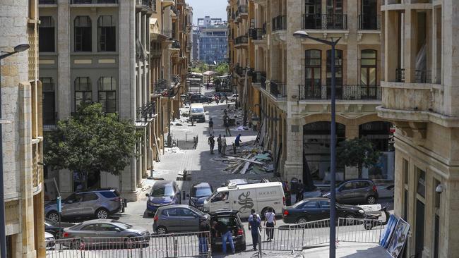 Workers clean debris in Beirut’s shopping district in the aftermath of the massive explosion. Picture: Joseph Eid/AFP