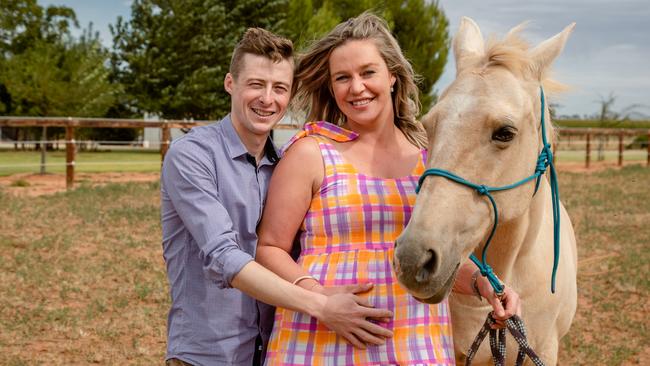 Jockey Harry Coffey with pregnant wife Tayla and horse Shakaya at their Swan Hill property. Picture: Rebecca Pilgrim