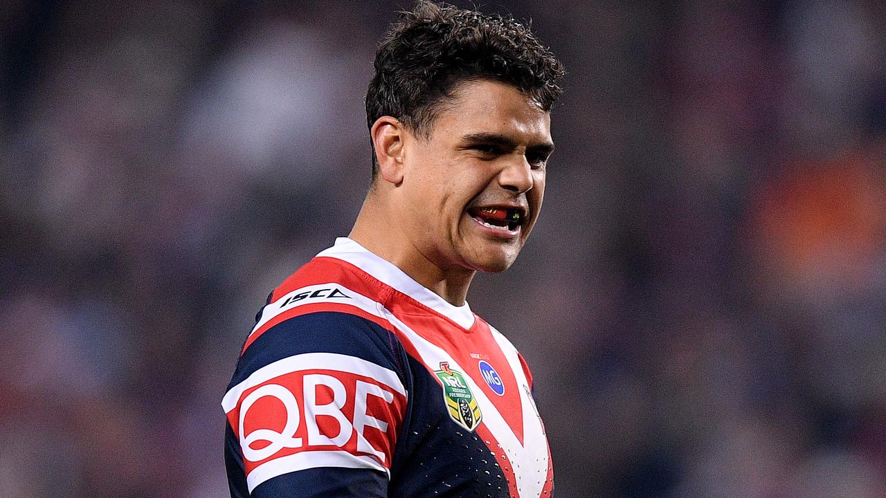 Latrell Mitchell is sweating on a tackle on Josh Dugan.