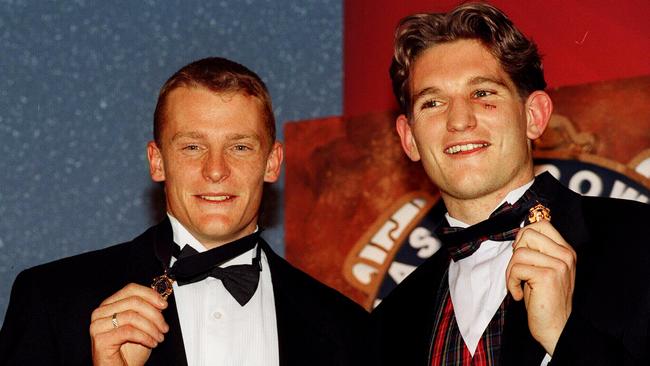 1996: Essendon’s James Hird sports a shiner as he wins the Brownlow Medal alongside Brisbane’s Michael Voss. The joint winners would go on to cement their names as greats of the game. Picture: Andrew Tauber