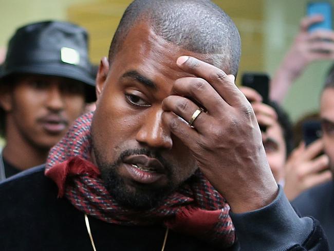 Kanye West appears very unimpressed with the level of attention his wife Kim Kardashian receives as they leave Kanye's Yeezus pop-up shop on Chapel Street in South Yarra, September 9, 2014. Picture: Mark Stewart