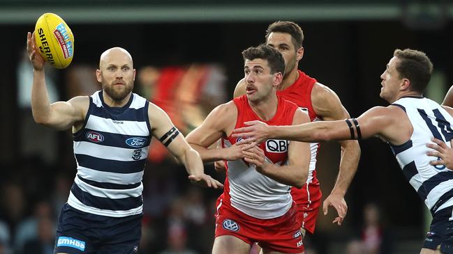 Gary Ablett gathers possession during Geelong’s win with Robbie Fox in hot pursuit. Picture: Phil Hillyard.