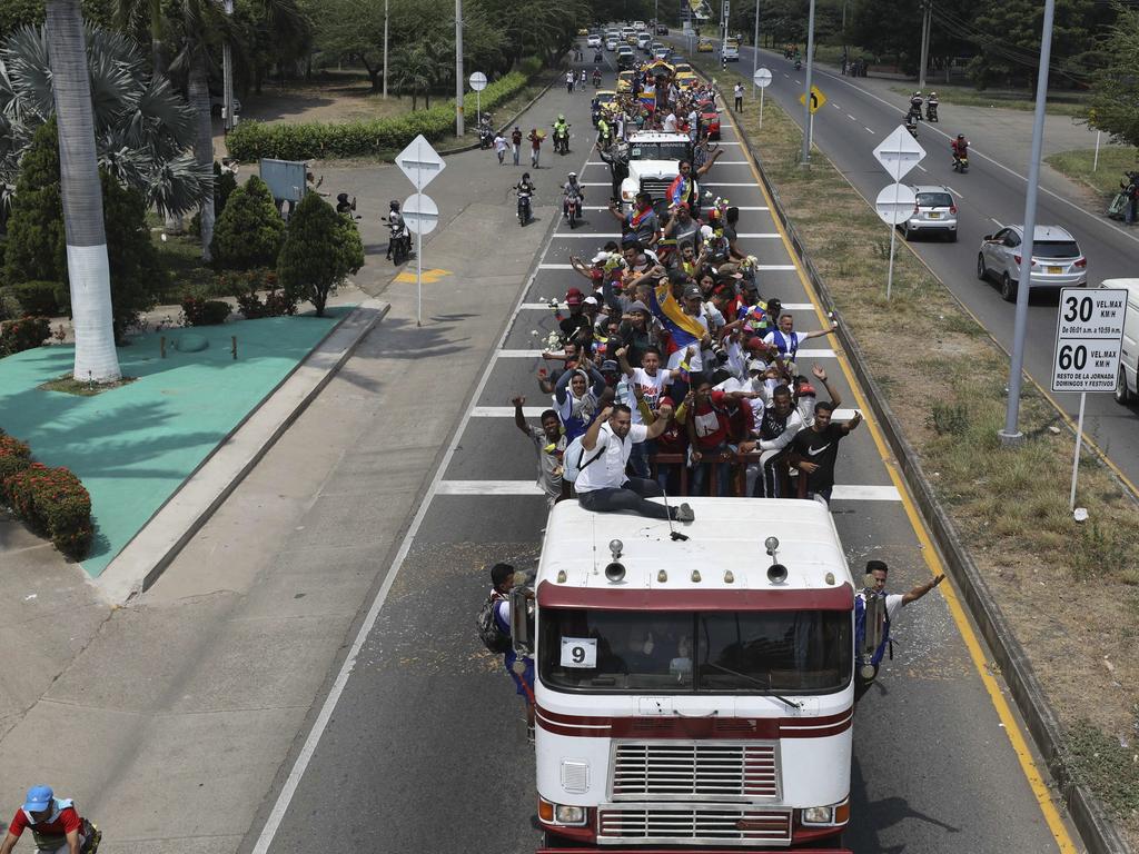 Venezuelans ride atop semi-trailers to the Simon Bolivar international bridge, accompanying US humanitarian aid destined for Venezuela. Picture: AP Photo/Fernando Vergara