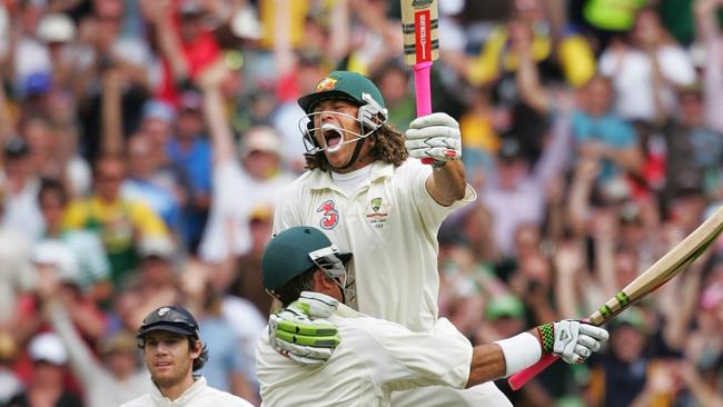 Andrew Symonds jumps into the arms of Matthew Hayden to celebrate his first Test century.