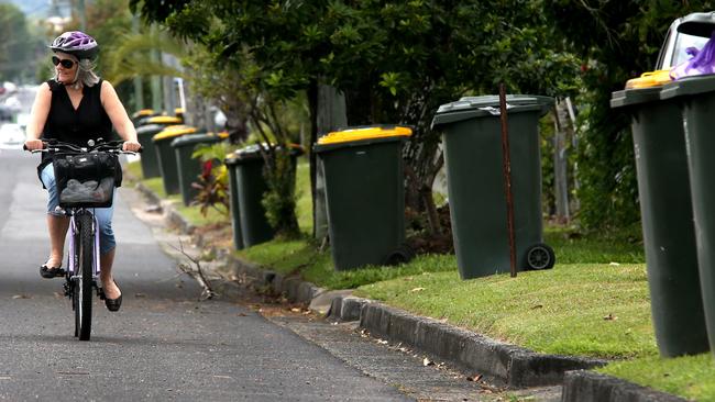 A cyclist rides past bins in Whitfield. Picture: File photo