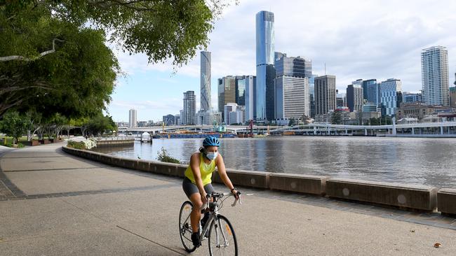 A cyclist rides through a deserted Brisbane after lockdown began. Picture: Bradley Kanaris/Getty Images