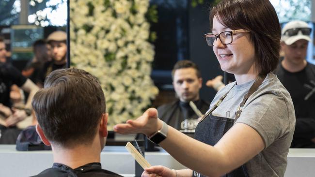 Trainee Beth Hepple works on Tim Miller’s tresses at Granville TAFE. Picture: Matthew Vasilescu