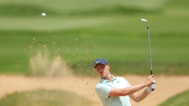 Cameron Davis of Australia plays a shot from the bunker on the 8th hole at The Lakes. Picture: Getty Images.