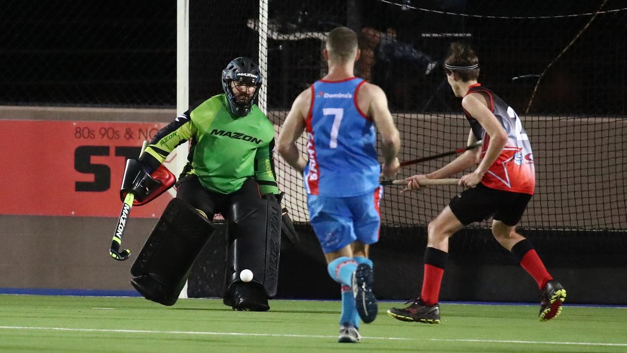 Saints goal keeper Damien Agius stops a shot at goal by Souths’ Ashton Schenk in the Cairns Hockey Association A Grade Men's grand final match between Saints and Souths. PICTURE: BRENDAN RADKE