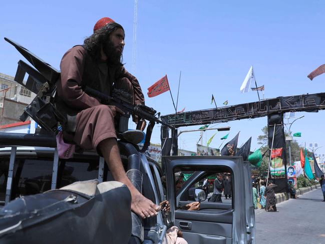 A Taliban fighter stands guard atop a vehicle near the site of an Ashura procession which is held to mark the death of Imam Hussein, the grandson of Prophet Mohammad, along a road in Herat on Thursday, amid the Taliban's military takeover of Afghanistan. Picture: Aref Jarunu/AFP