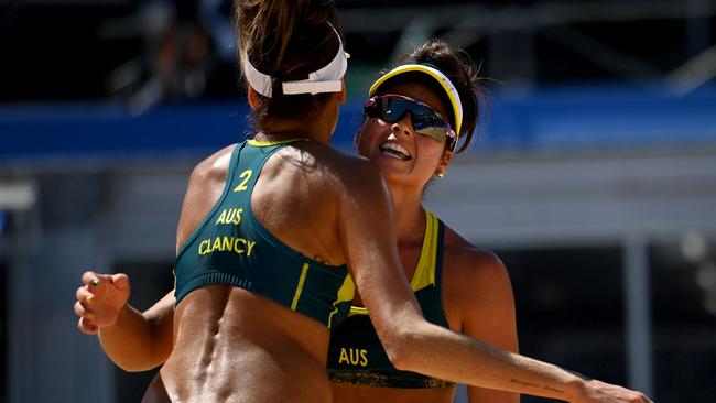 Artacho del Solar and Australia's Taliqua Clancy, left) celebrate a point in their women's beach volleyball semi-final match between Australia and Latvia. Picture: Martin Bernetti/AFP