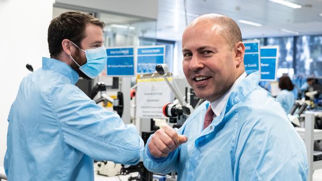 Federal Treasurer Josh Frydenberg meets a worker on the production line at bionic ear maker Cochlear’s Sydney headquarters. Picture: James Gourley