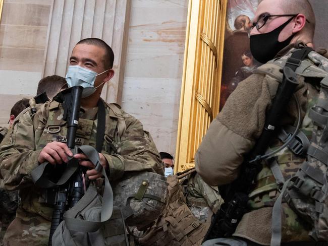 Members of the National Guard walk through the Rotunda of the US Capitol in Washington, DC, January 13, 2021, ahead of an expected House vote impeaching US President Donald Trump. - The Democrat-controlled US House of Representatives on Wednesday opened debate on a historic second impeachment of President Donald Trump over his supporters' attack of the Capitol that left five dead.Lawmakers in the lower chamber are expected to vote for impeachment around 3:00 pm (2000 GMT) -- marking the formal opening of proceedings against Trump. (Photo by SAUL LOEB / AFP)