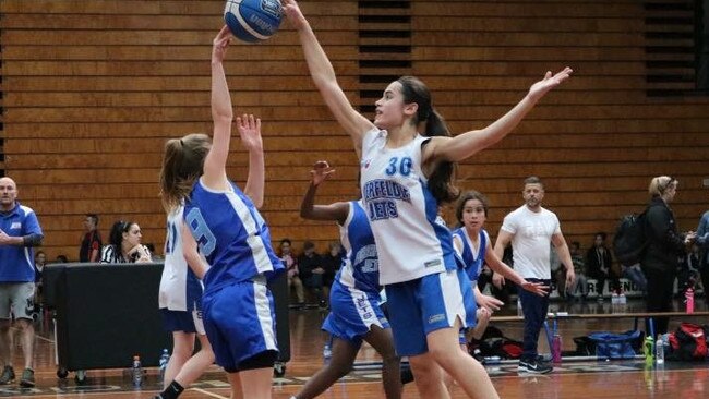 Moonee Valley basketball star Taylah Babic (right) leaps high during a recent domestic tournament.