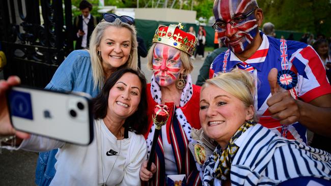 People wearing Union Flag face paint pose for a photo. Picture: Getty Images