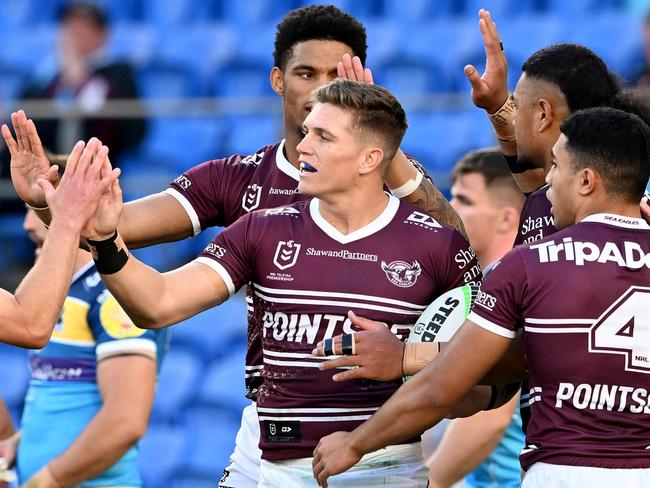 GOLD COAST, AUSTRALIA - AUGUST 14: Reuben Garrick of the Sea Eagles is congratulated by team mates after scoring a try during the round 22 NRL match between the Gold Coast Titans and the Manly Sea Eagles at Cbus Super Stadium, on August 14, 2022, in Gold Coast, Australia. (Photo by Bradley Kanaris/Getty Images)