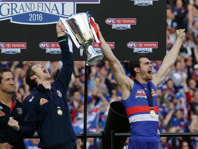 2016 AFL Grand Final match between the Western Bulldogs and the Sydney Swans at the Melbourne Cricket Ground (MCG), Melbourne, Australia on October 1, 2016. Injured Bulldogs captain Bob Murphy & with Grand final day captain Easton Wood with Luke Beveridge & 1961 premiership player John Schultz on the victory dias with 2016 premiership cup Picture:Wayne Ludbey