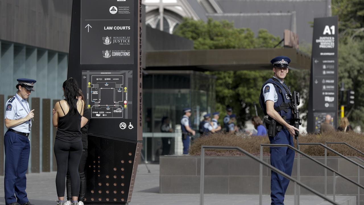 Police stand guard outside the district court building in Christchurch. Picture: AP Photo/Mark Baker