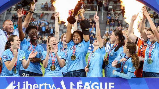 Sydney FC players celebrate with the trophy after winning the A-League Women’s grand final in April. Picture: AFP