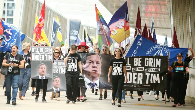 Union protesters from the Queensland Council of Unions march through the Brisbane CBD yesterday. Picture: AAP/Jono Searle