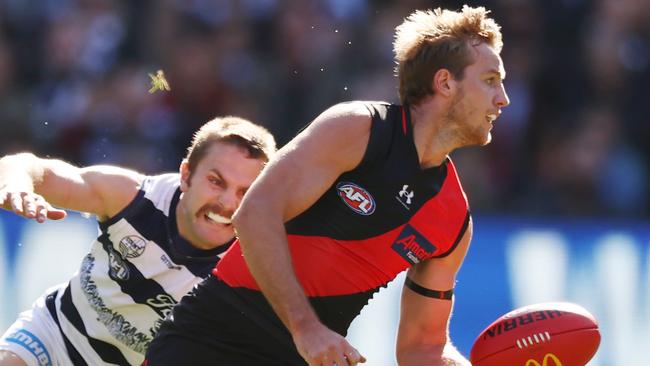 Darcy Parish of the Bombers in front of Tom Atkins of the Cats. Picture: Michael Klein