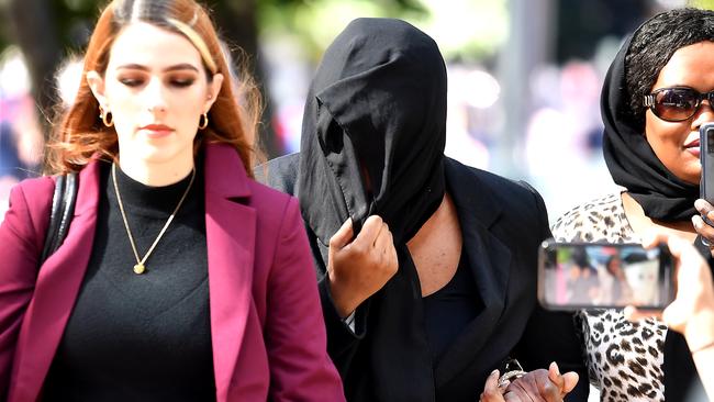 Diana Lasu’s defence lawyer said her client (centre, face covered) had suffered extreme humiliation. Picture: NewsWire / John Gass